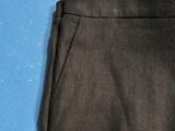 a close up of a pair of black pants on a blue surface