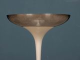 a white table with a silver bowl on it