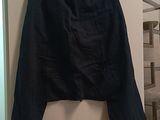 a black skirt hanging on a wall in a room