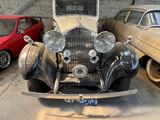 many old cars parked in a garage next to each other