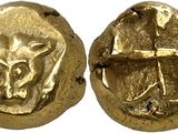 a close up of two gold coins with animals on them