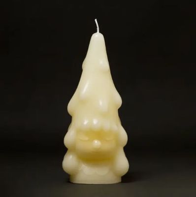 une bougie blanche est allumée sur un fond noir