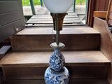 un vase bleu et blanc posé sur un escalier