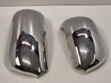 two chrome mirrors on the side of a white table