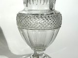 a glass vase that is sitting on top of a table
