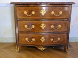 a wooden chest of drawers on a hard wood floor