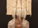 an image of a sculpture of a woman ' s head with an apple in front of it