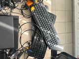 a computer keyboard and a mouse on a desk