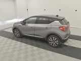 the rear end of a silver nissan suv parked in a garage