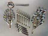 a lot of silverware on a table with spoons and forks