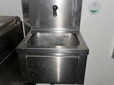 a stainless steel sink in a public restroom