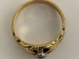 an image of a gold ring with a black diamond