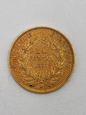 a close up of a gold coin on a white surface
