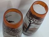 two vases that have been painted with trees on them