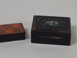 two small wooden boxes sitting on top of a white surface