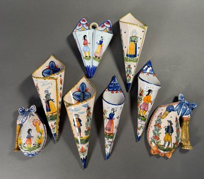 several pieces of porcelain art are displayed on a gray surface