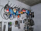 a lot of tools hanging on the wall in the garage