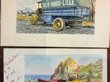 two paintings of old cars on display on a table