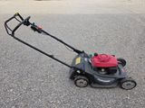 an image of a lawn mower sitting on the ground
