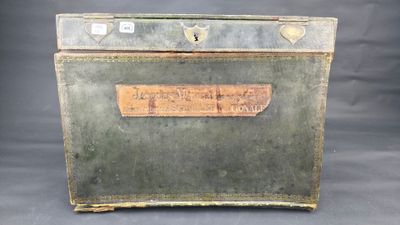 an old metal box with a label on it sitting on a table