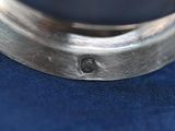 a close up of a metal object on a blue cloth