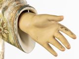 a statue of a person with a hand on it ' s arm