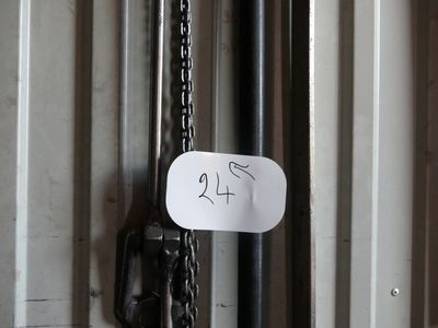 a sign hanging on a door with a chain attached to it