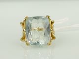 a close up of a ring with an aquamarine stone in it