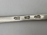 a close up of a spoon on a white surface