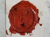 a wax seal on a piece of paper on a table