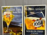 two posters of a beer and a glass of beer on a table