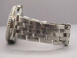a close up of a watch on a white surface