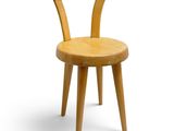 wooden chair with bent legs and a wooden seat on a white background