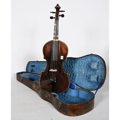 an old violin sits in a case on a white surface