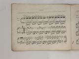 an old book with a page of music written in it