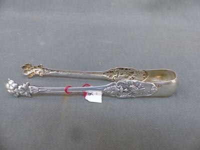 two spoons that are sitting next to each other on a table