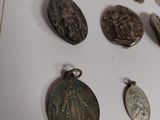 a lot of silver coins on a white surface