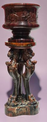 an image of a vase on a stand with two dogs on it