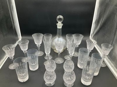 many glasses and a decanter sitting on a table