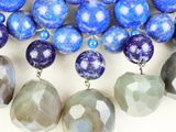 necklace made of blue and grey beads with silver accents on a white background