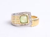 an image of a ring with a green stone in it