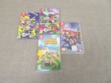 quatre jeux Nintendo Wii posés les uns à côté des autres sur un tapis