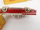 a red and white toy airplane next to a yellow box