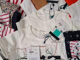 a lot of clothes that are laying on a bed