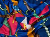 a close up of a blue and yellow scarf with a picture of a man on a skateboard