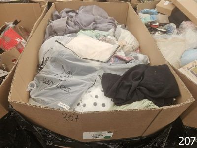a cardboard box filled with clothes and other items
