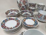 a lot of plates and cups on the table