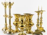 a lot of gold candles that are sitting on a table