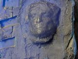 a close up of a sculpture of a man ' s face on a wall