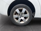a close up of a white car with a flat tire